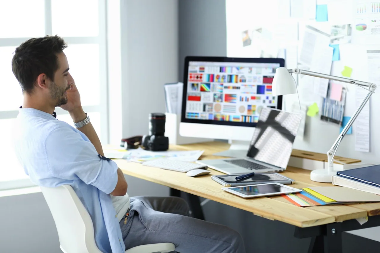 Web designer working on creative digital design projects at modern workspace